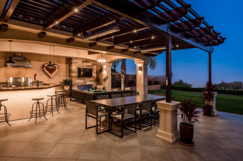Outdoor kitchen luxury featuring a covered outdoor entertaining space with a stone patio.
