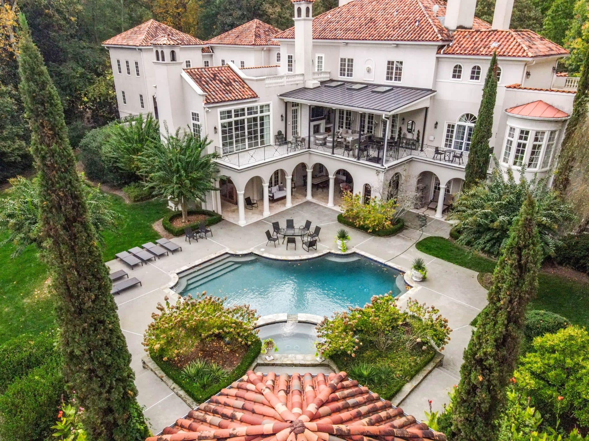 Aerial view of Mediterranean estate with courtyard pool and covered terrace