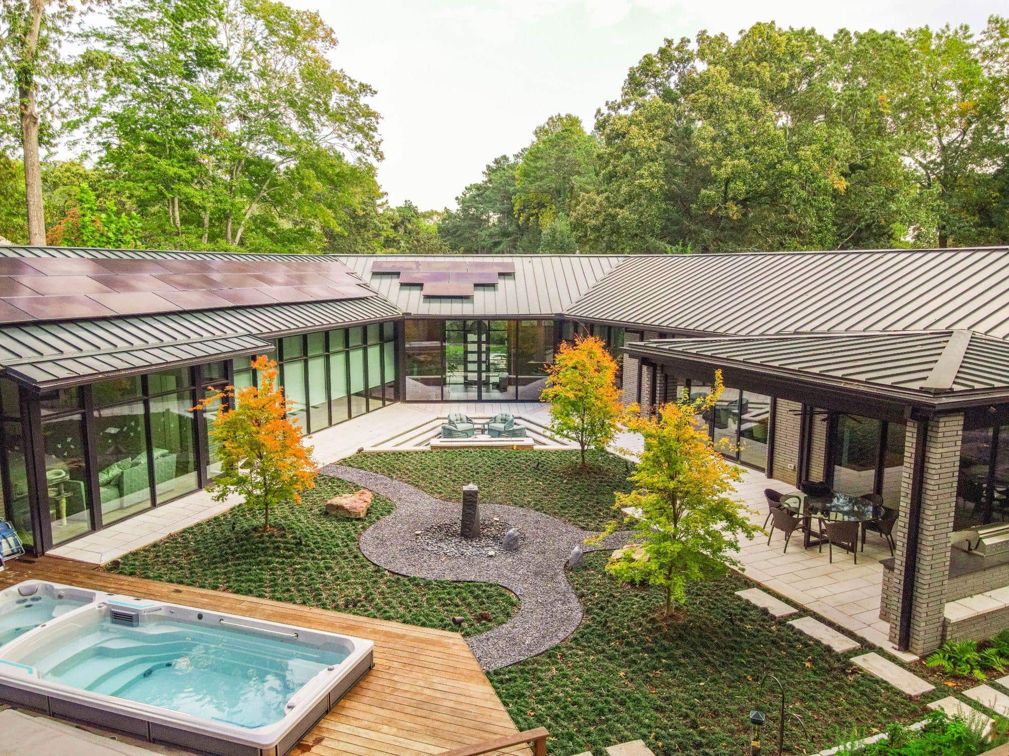 Contemporary courtyard with geometric planting beds and integrated spa