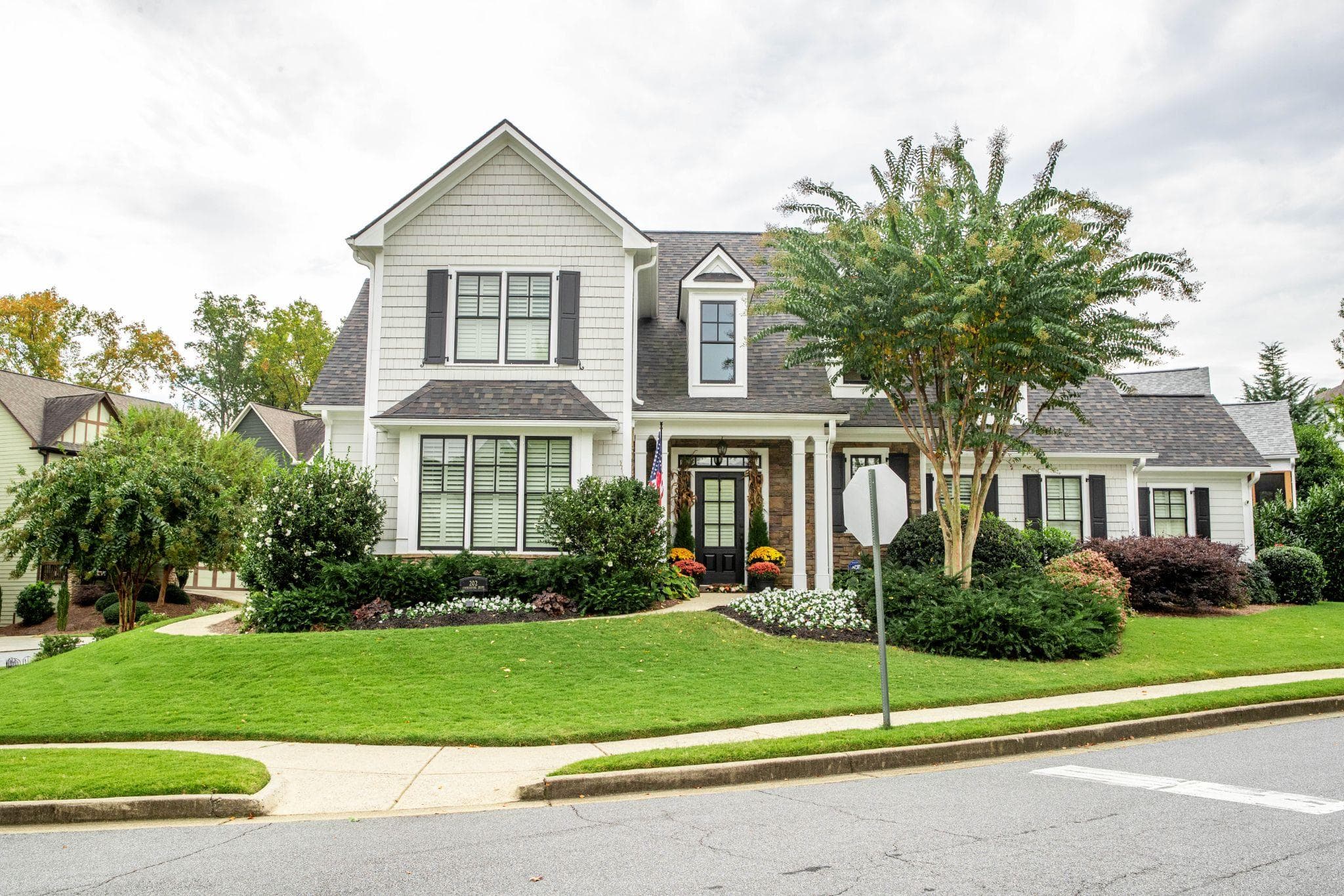 Suburban home with manicured lawn and layered foundation plantings